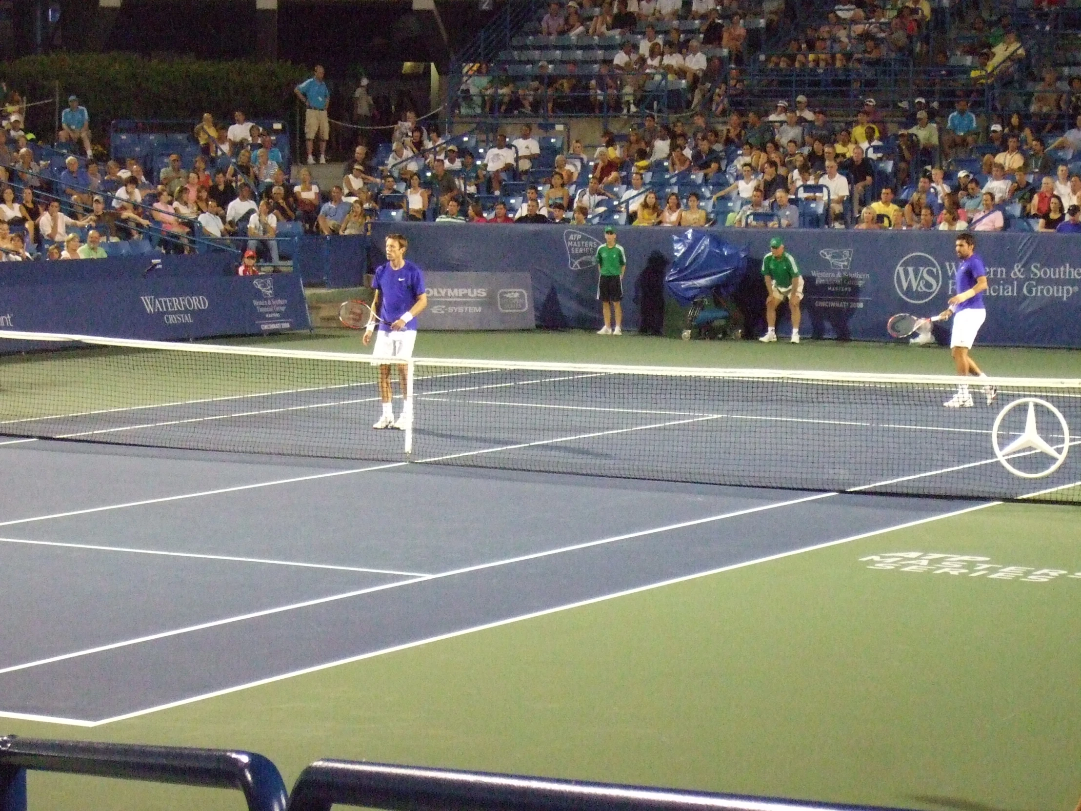 a group of people that are playing in a tennis game