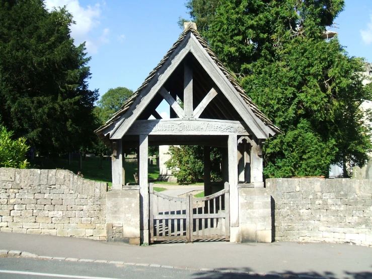 a stone gated building with a wood structure