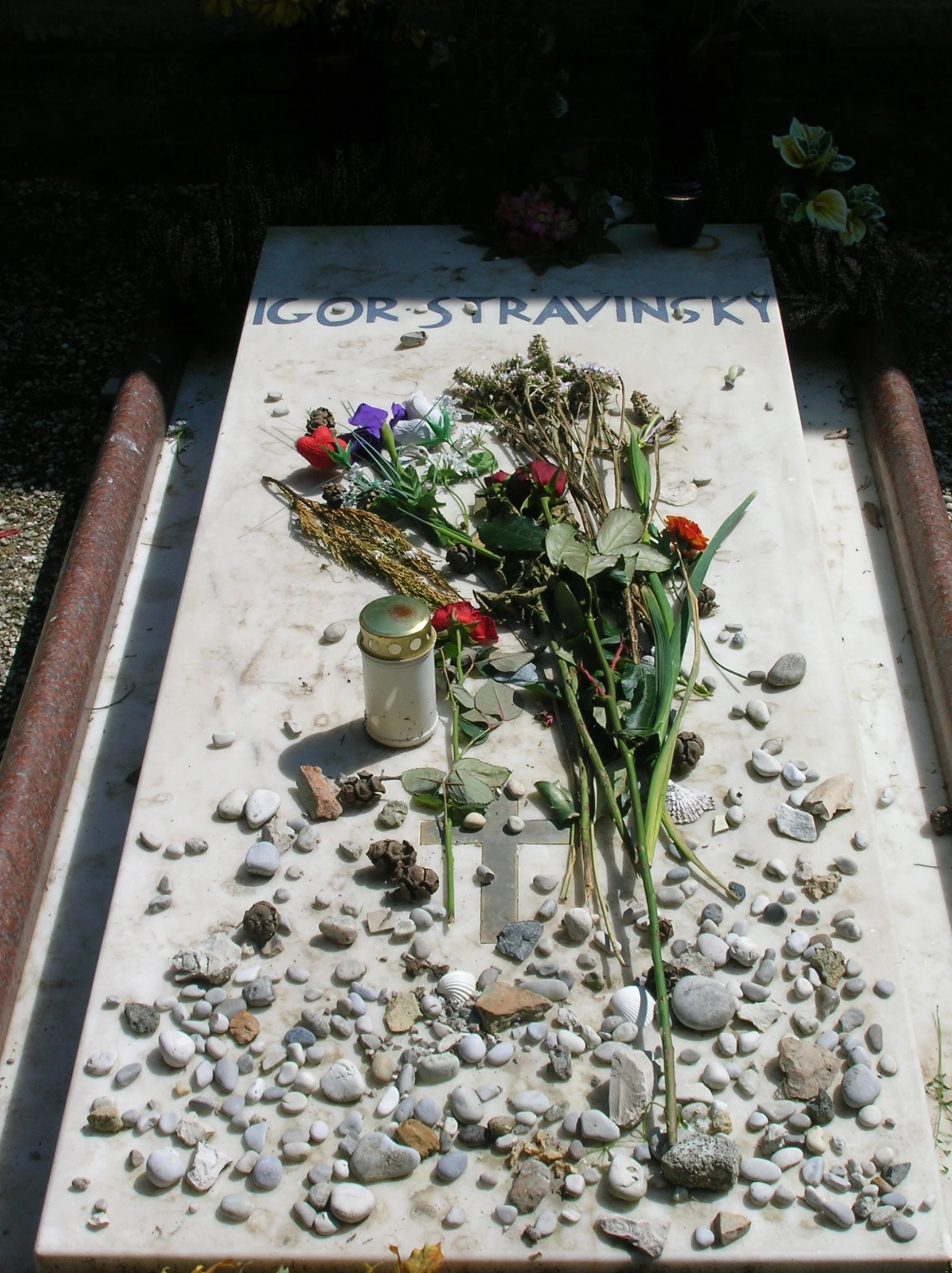 a dead body covered in stones and flowers