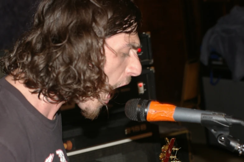 a man standing in front of a microphone singing