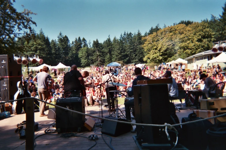 some people are playing music together at a festival