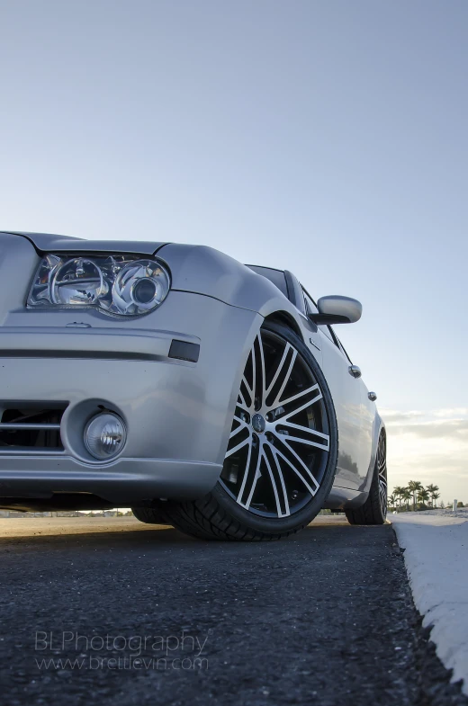 a white sports car parked on the side of a road