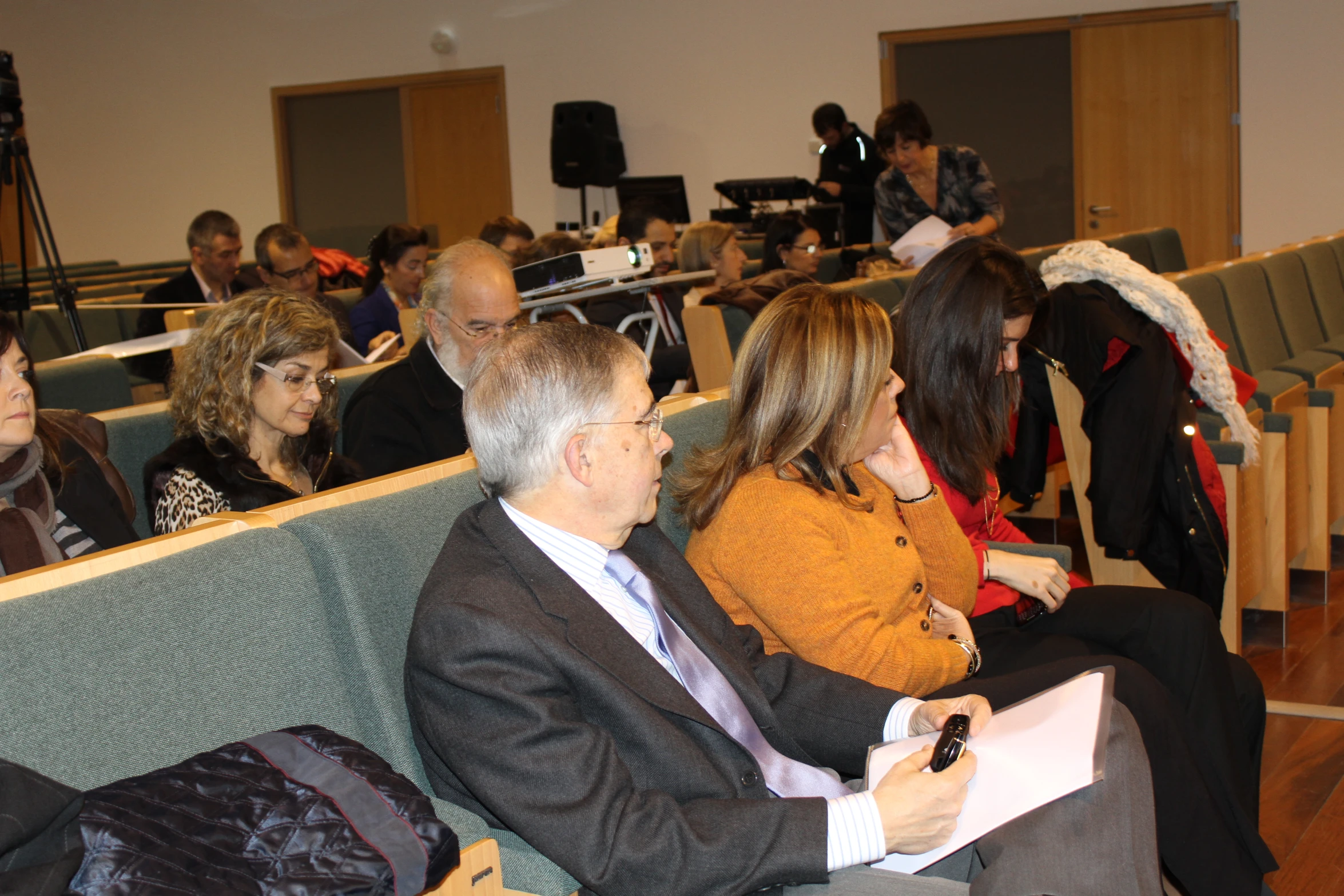 a group of people sitting together in a meeting room