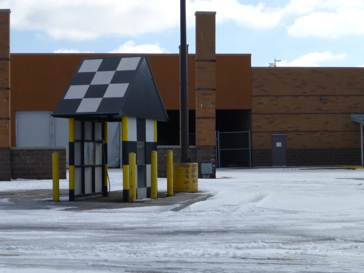 a store next to a shopping center with snow on the ground