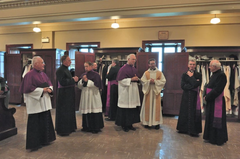 priests are standing in a line at the end of a ceremony