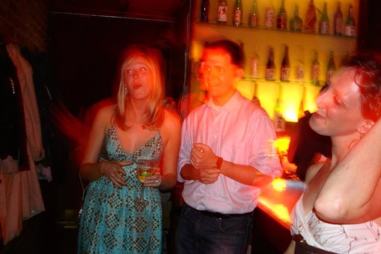 three women and two men enjoying a bar or club