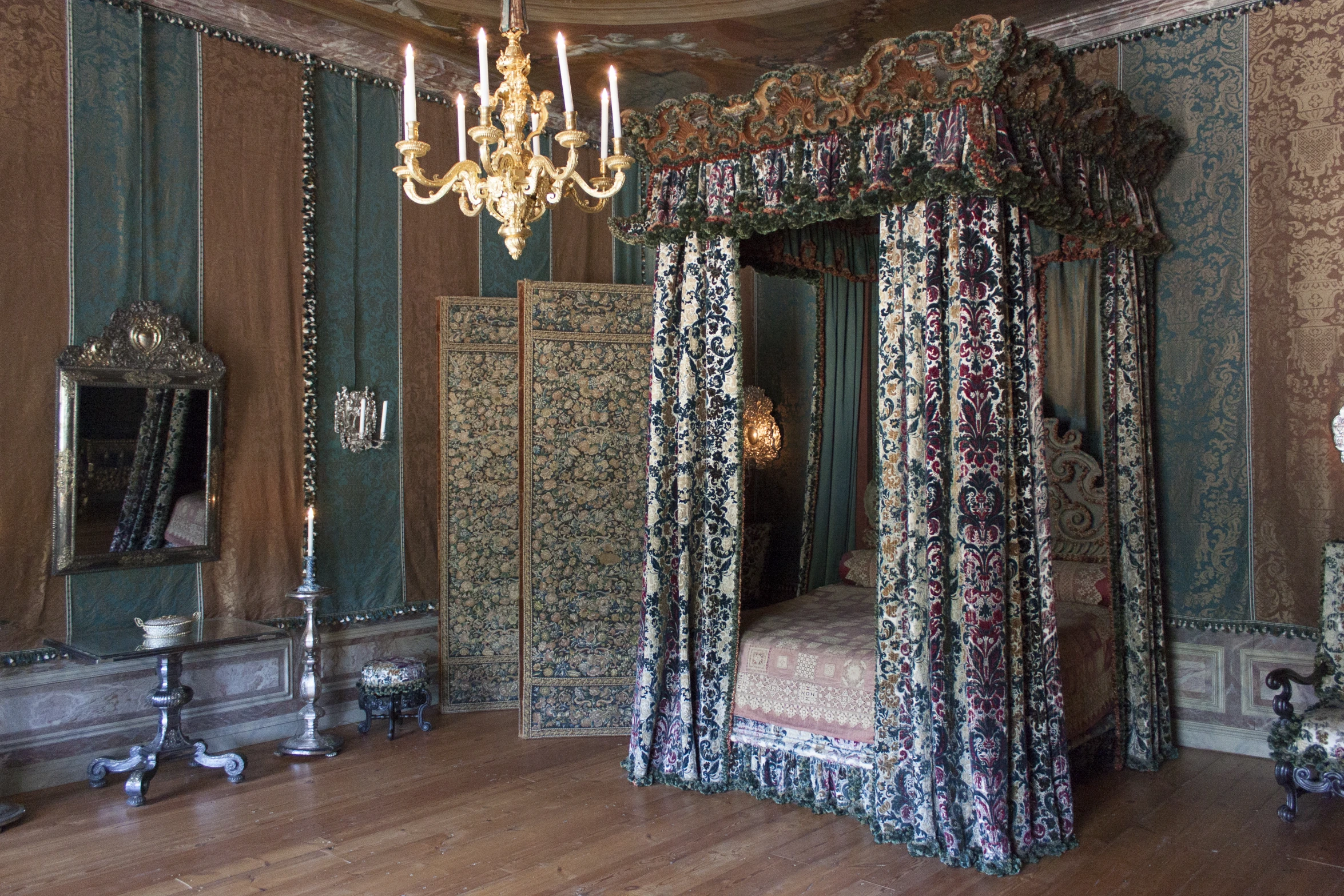 a fancy room with green walls and white chandelier