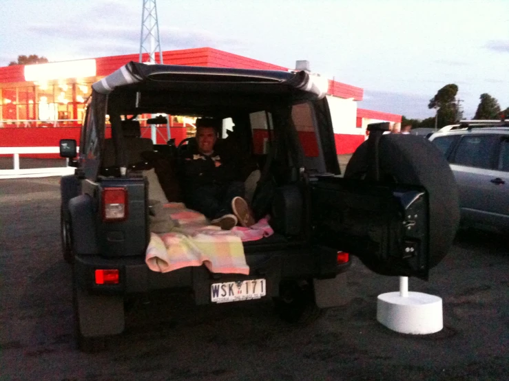 a man is sitting in the back of a vehicle