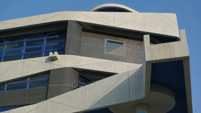 the top of a modern building with a circular window