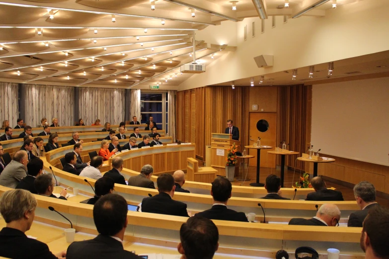 a big room filled with people and lots of chairs