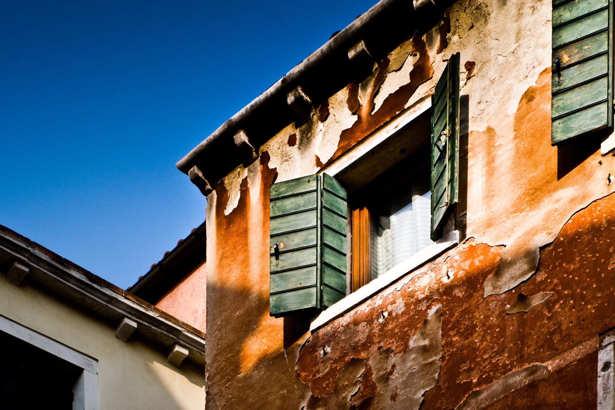 an image of an old building with shutters