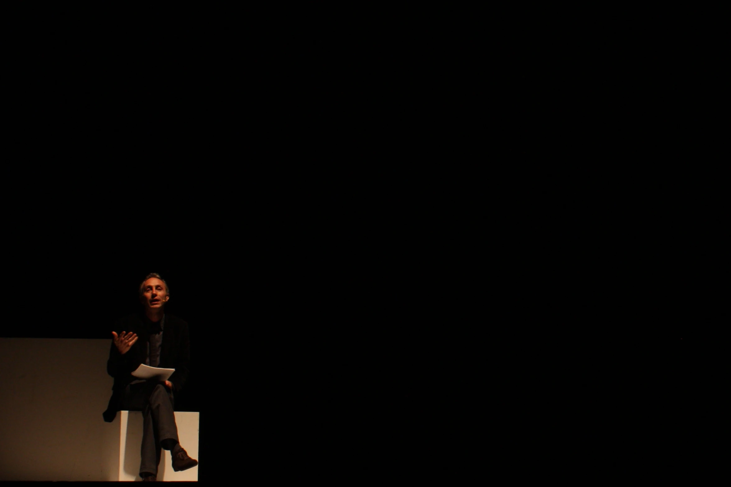 the woman is waiting at a dark stage to speak