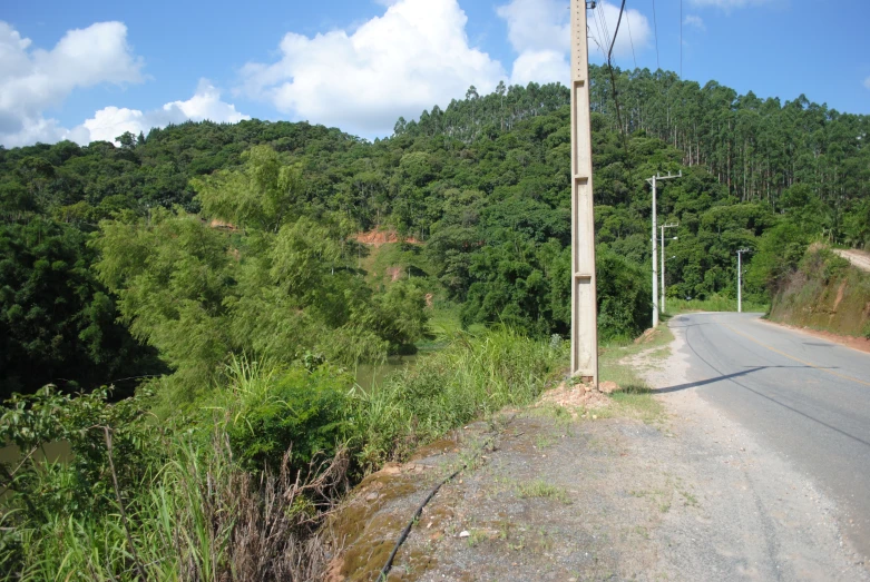 the road is running parallel to a hillside