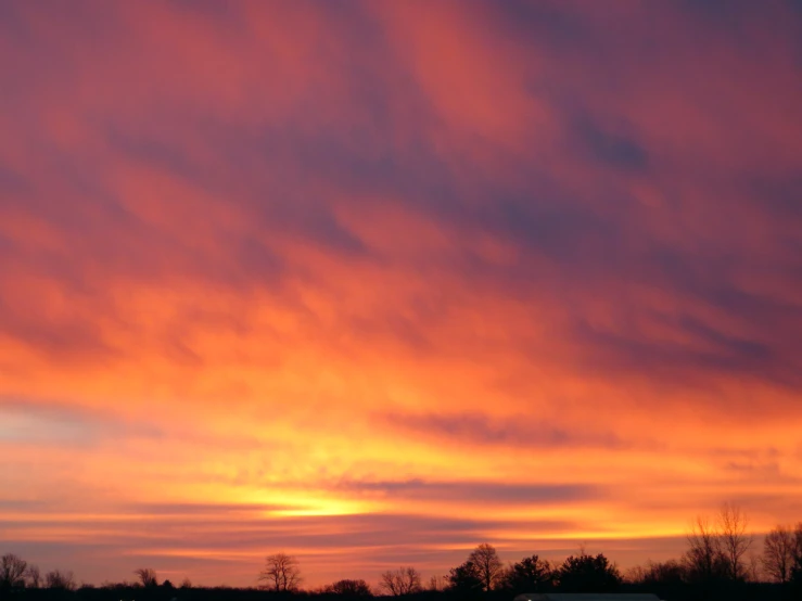 there is a very cloudy sky and the sun shining bright