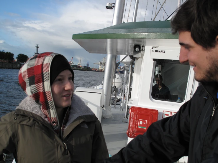 a man shaking hands with a woman on a boat