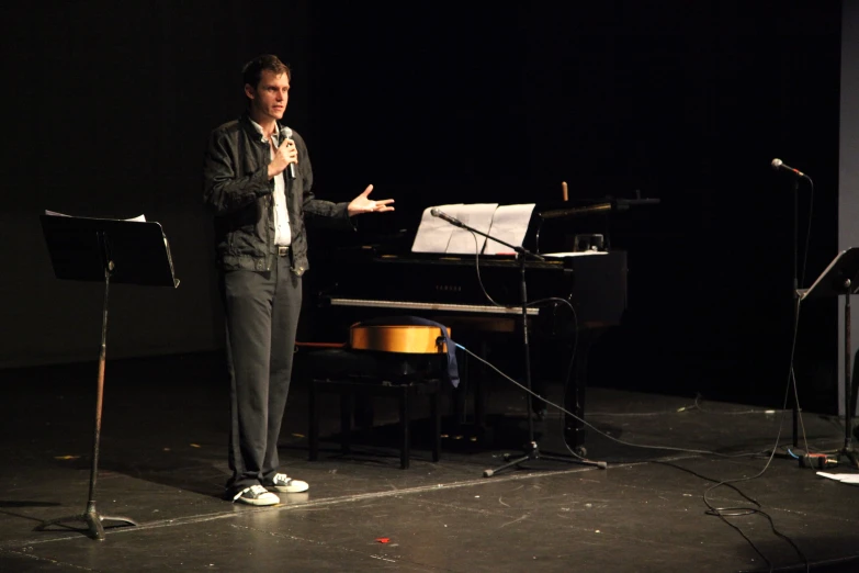 a man is giving a presentation with three microphones