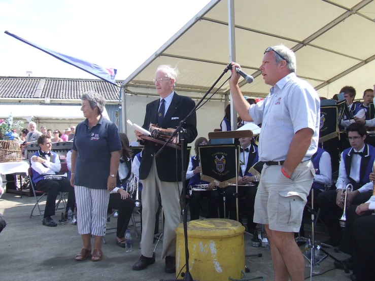 a band playing musical with people watching