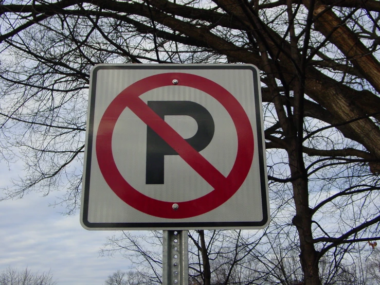 there is a sign with an upside down letter placed in a tree