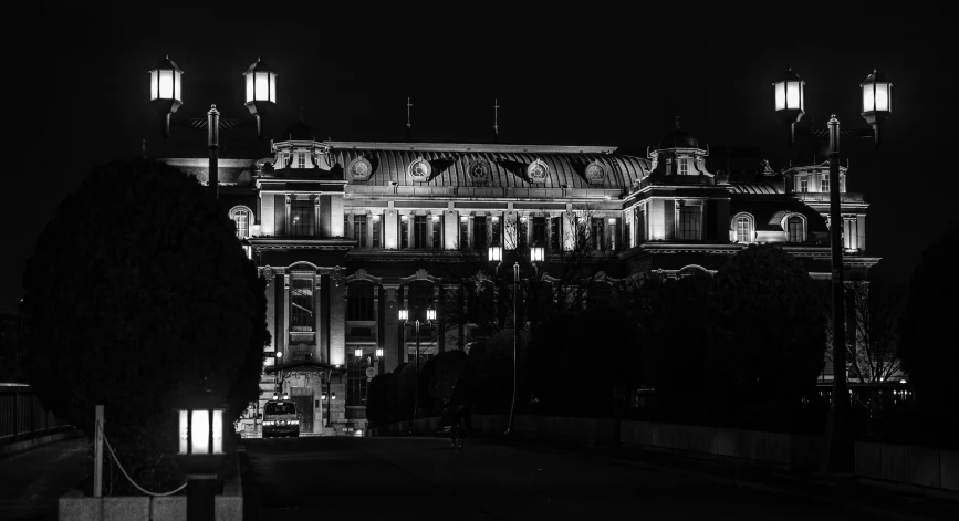 an ornate building illuminated by lights and trees