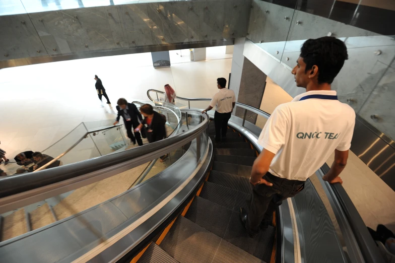 people are riding on escalators in an airport