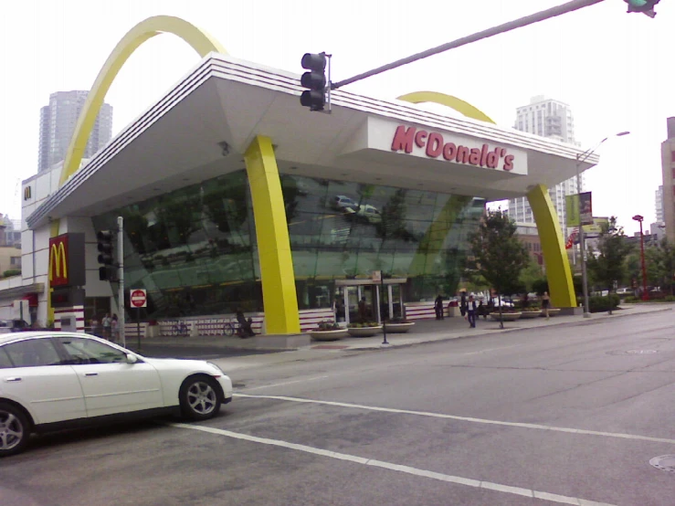 the car is going down the road outside a mcdonalds