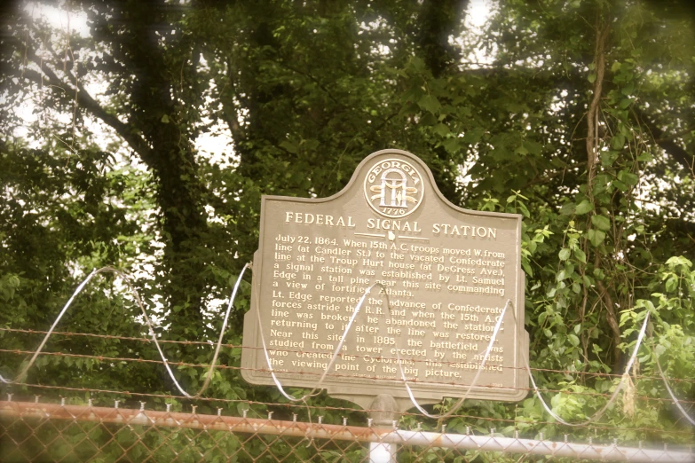 a memorial sitting behind a barbed wire fence