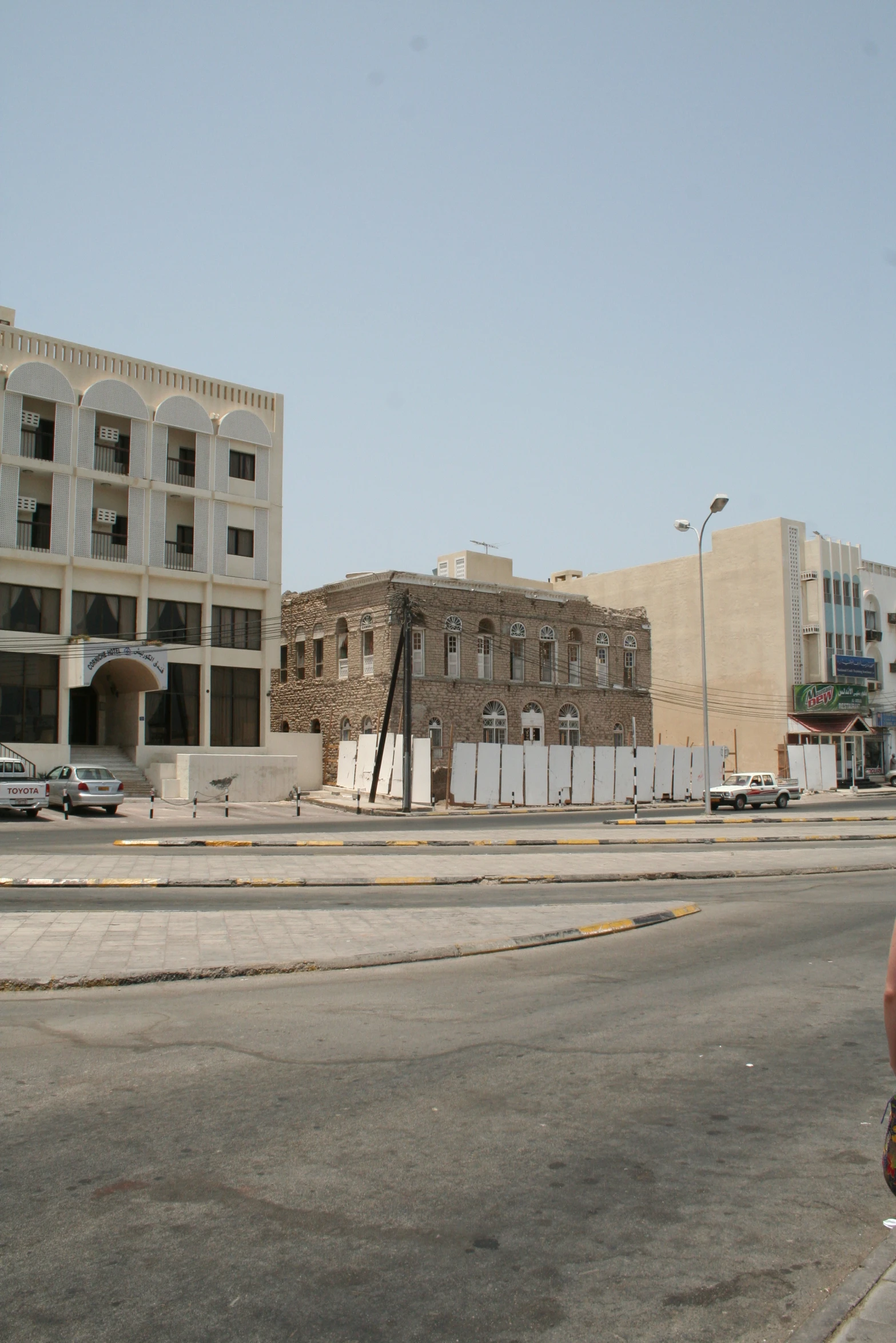 tall building sitting next to a street on top of a hill