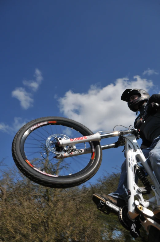 a man with a helmet is doing stunts on his bike