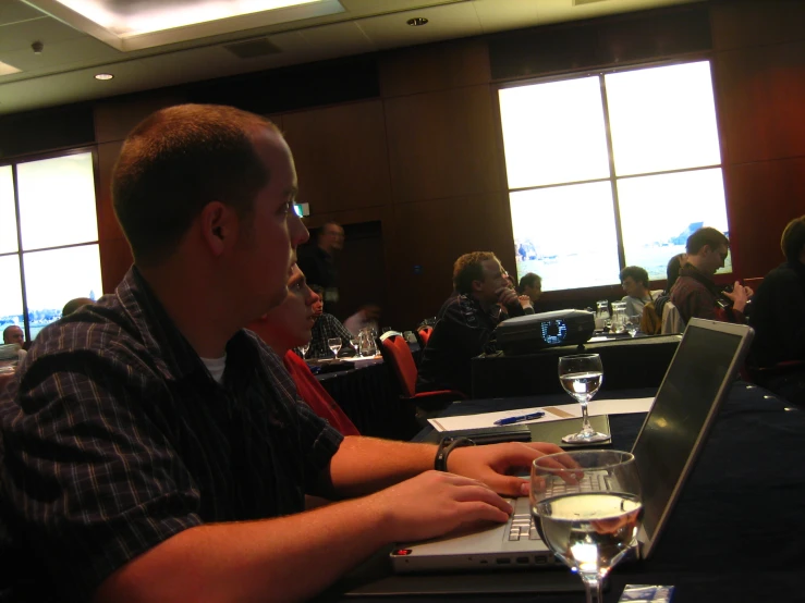 a man working on his laptop at a conference