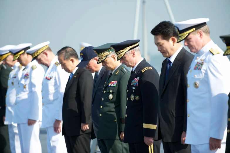 two men in military dress standing next to each other