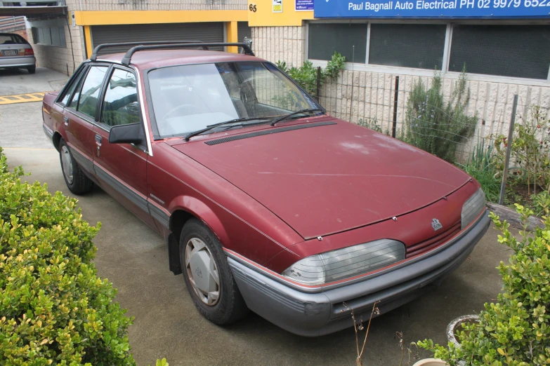 a car parked outside a building near a sign