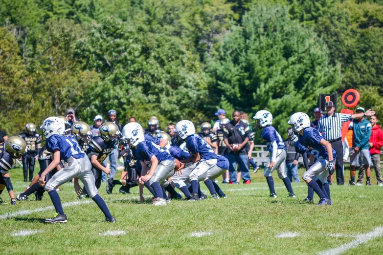 a group of s in uniform and on football uniforms playing a game