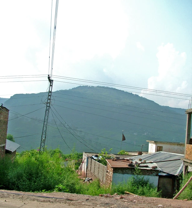 an out buildings and mountain are in the distance