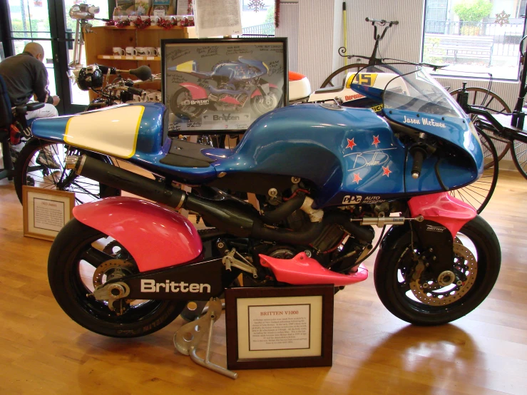 a blue, red and black motorcycle is on display