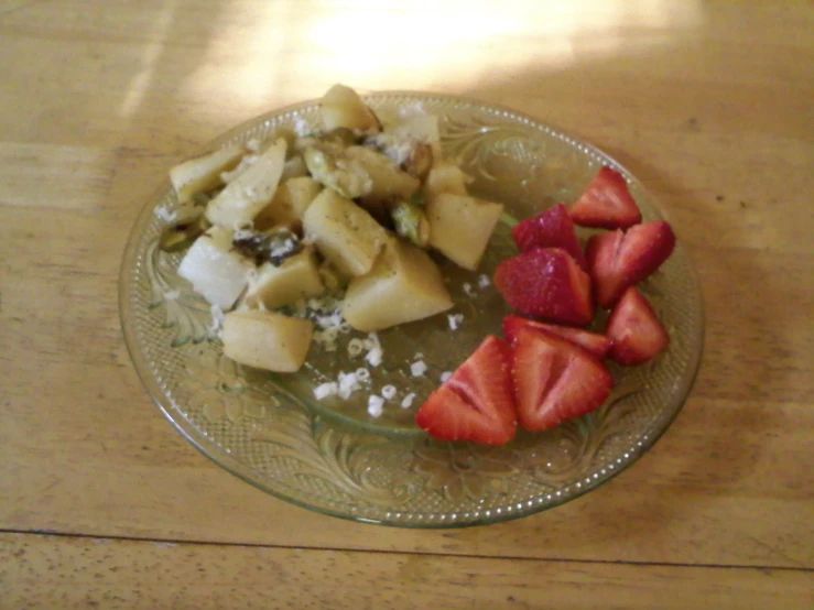 strawberries are arranged on top of a glass plate