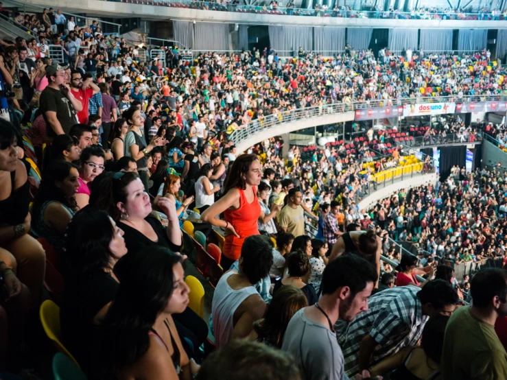 a crowd of people sitting in an empty room