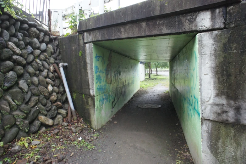 a road that has graffiti on the sides