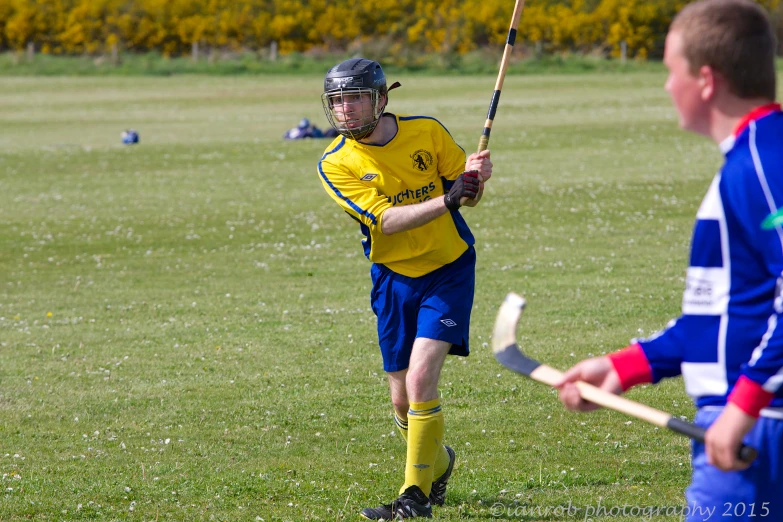 a man holding a lacrosse racket on a field