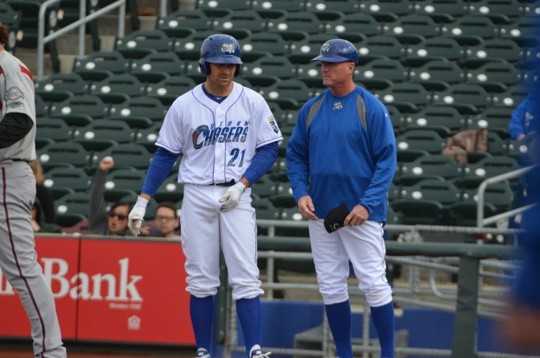 three baseball players talking on the field