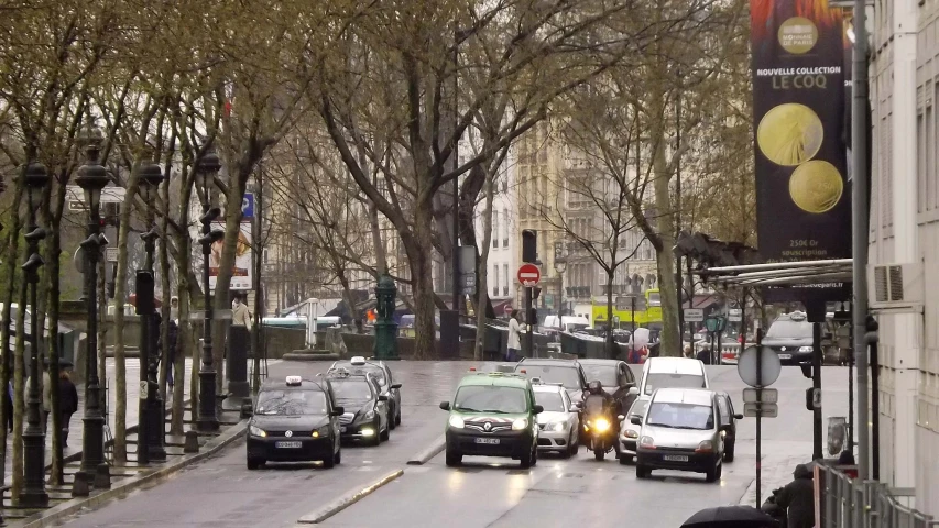 a group of cars riding on a city street