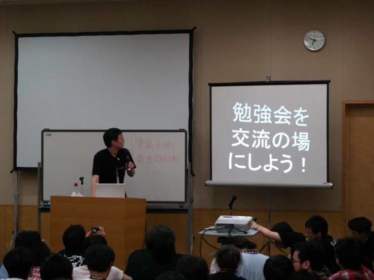 a man speaking at the end of a lecture