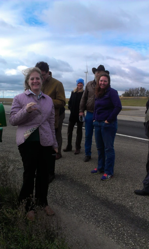 a group of people stand in the middle of a road