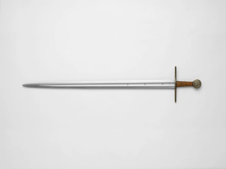 a sword laying on a counter top under a knife