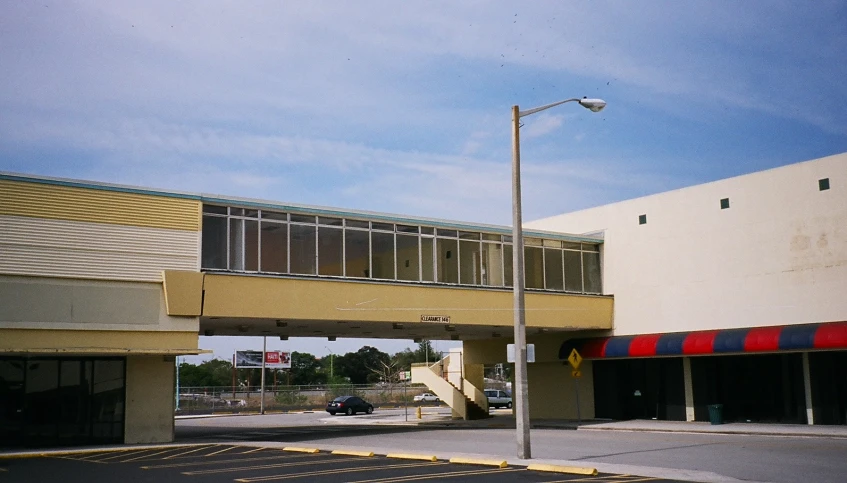 an empty street outside of a building with parking spots