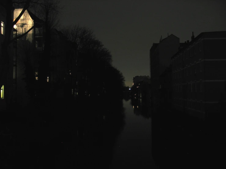 a black night time picture with light on a street