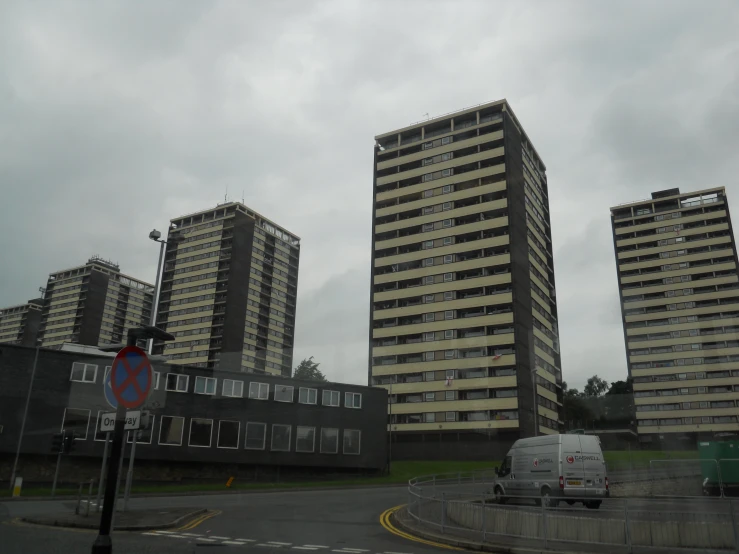 some very large buildings in the middle of a road