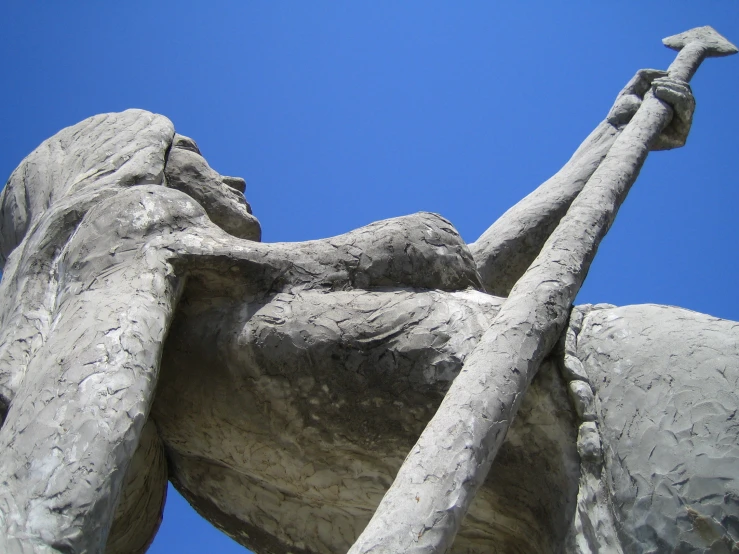 a large stone statue sits with its arm spread out