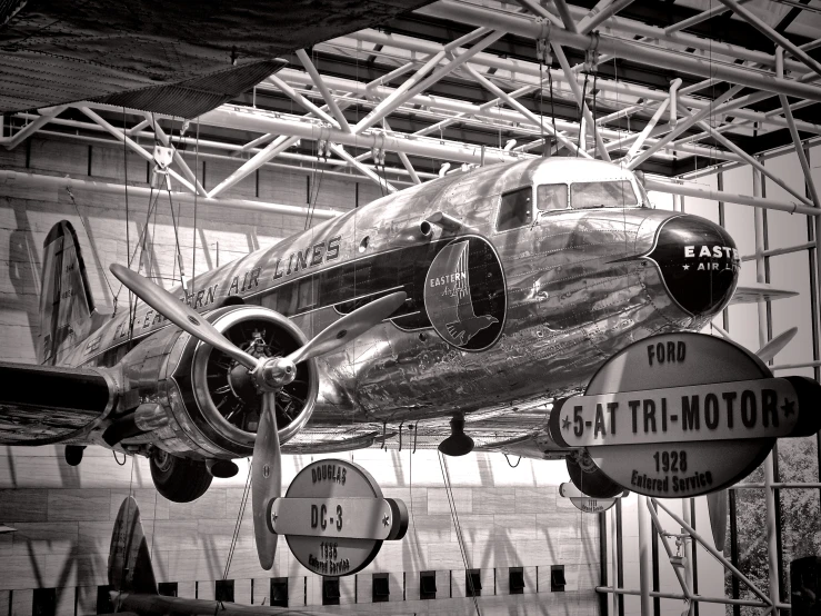 an old airplane is suspended in the hangar