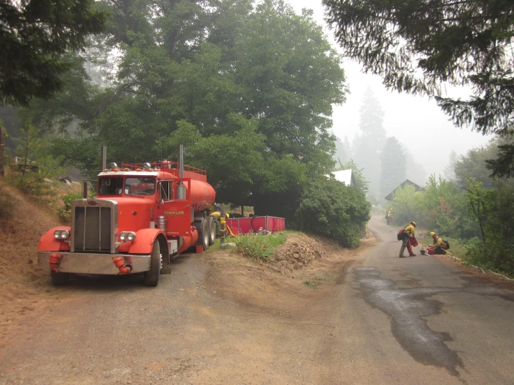 a large truck parked on the side of a road next to another truck