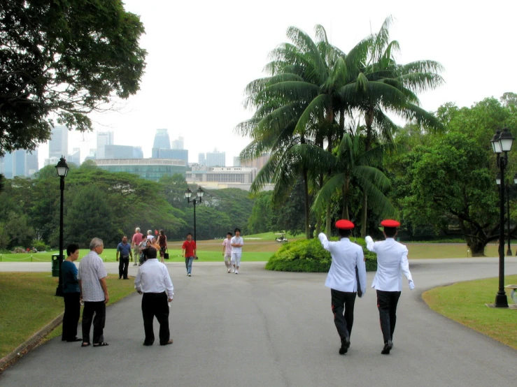 the men in red hats are walking down the street